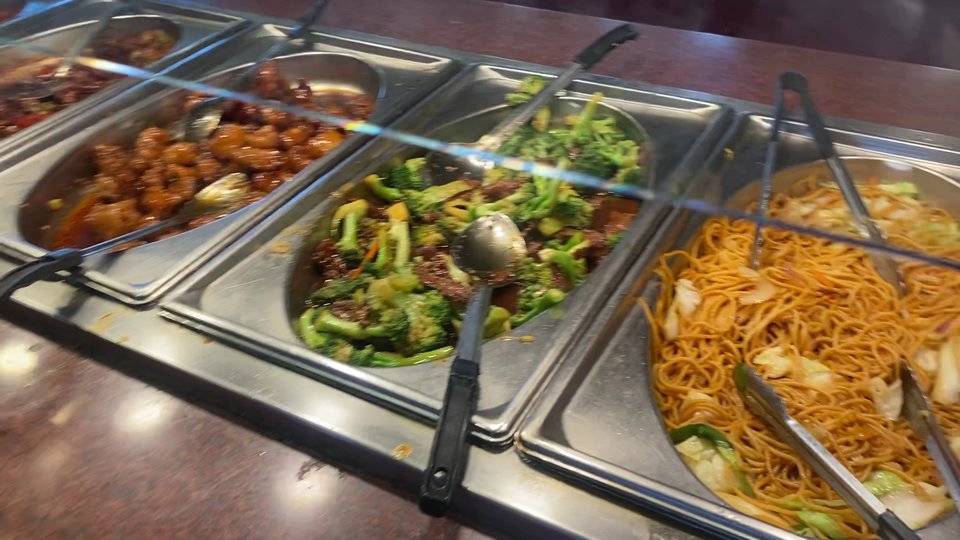 Salad bar beside warm buffet stations.
